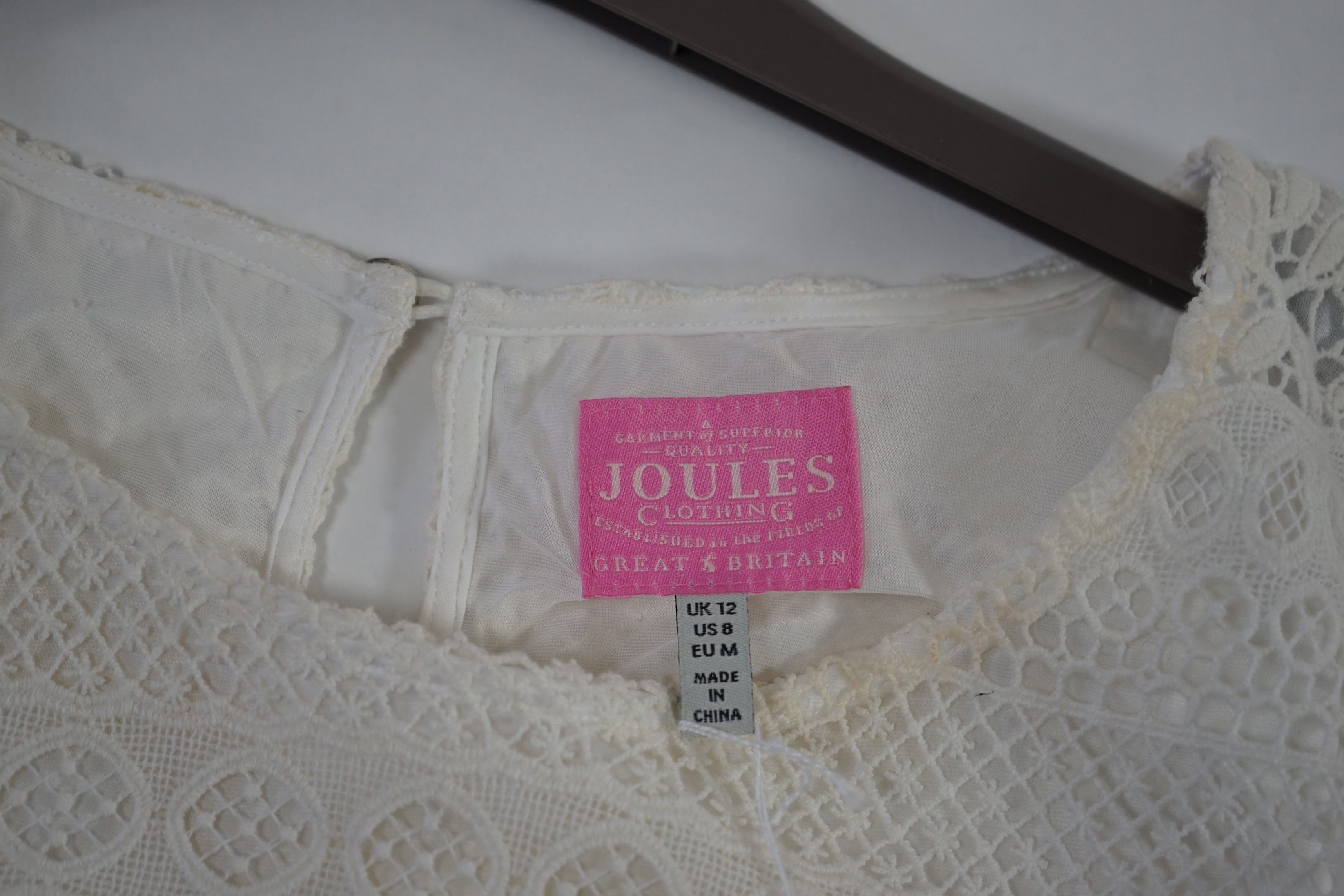 An assortment of lady's clothes including a knitted coat/cardigan, a Sahara velvet overshirt and linen trousers, a Joules white cotton lace top, an Aiger dark grey trouser and long sleeve lounge suit, etc. Sizes 14-16 Pr
